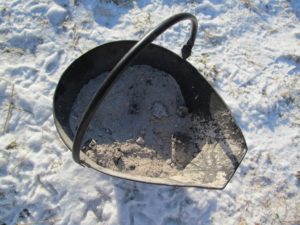 bucket of wood ash in snow