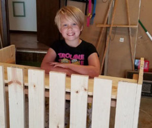 Aurora's lemonade stand and salesman smile.