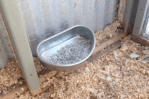 Grey grit in a metal dish.