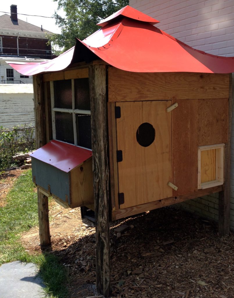 Wood hen house with bright red pagoda style roof