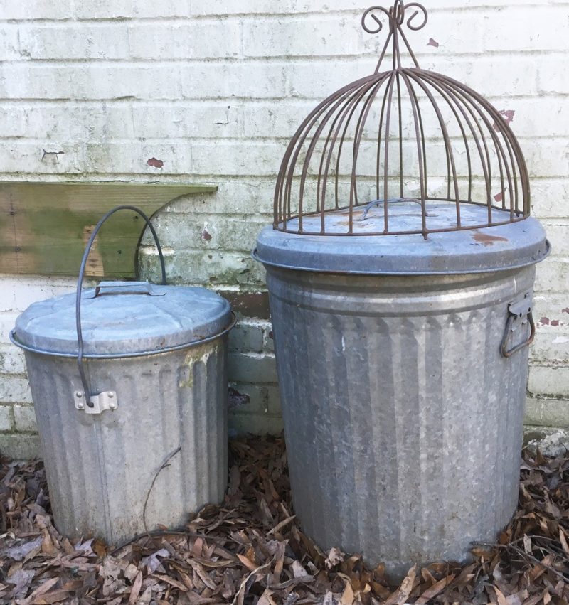 two galvanized trash cans